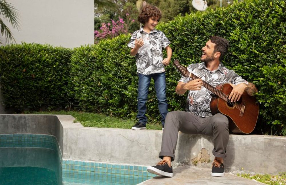 pai-filho-na-beira-da-piscina-tocando-violao